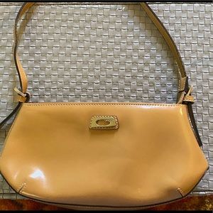 Small Guess shoulder purse. Goldish/tan color.